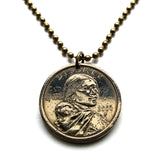 USA Dollar coin pendant Sacagawea Lemhi Shoshone native American Indian Agaidika Lewis & Clark expedition Fort Washakie Nevada Akaitikka Idaho Louisiana Salmon Eater North Dakota Missouri Rocky Mountains Wyoming Sakakawea Lemhi Pass Montana n003208