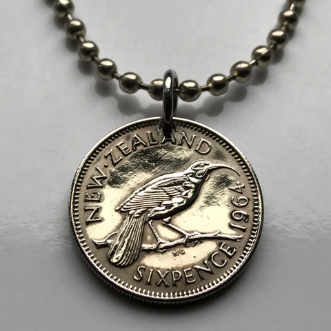 1965 New Zealand 6 Pence coin pendant huia bird wattlebird Wellington Auckland Marae Koruru Hawaiki North South Island haka dance Te Reo Te Waipounamu Christchurch Hamilton Tauranga Cook Strait Waikato New Zealanders Milford Sound Polynesia n000106